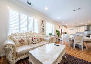 a living room with a white couch and a table at 17-19ppl BTW Dsny Hllywd GarageParking Yard Grill in Monterey Park