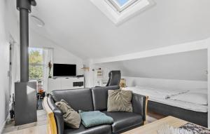 a living room with a couch and a bed at 2 Bedroom Lovely Home In Hejls in Hejls