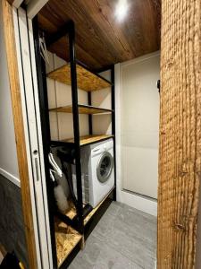 a small kitchen with a washing machine in a room at Appartement Chic et Cosy in Aime-La Plagne