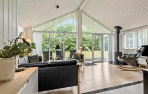 a living room with a couch and a fireplace at Awesome Home In Glesborg With Sauna in Glesborg