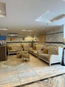 a large living room with couches and a table at فندق ام جي كراون 3 - MG Crown Hotel 3 in Medina