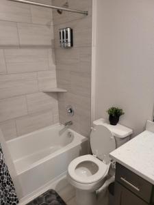 a bathroom with a toilet and a tub and a sink at Ts3 Houston in Missouri City +32 photos