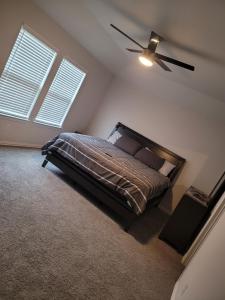 a bedroom with a bed and a ceiling fan at Ts3 Houston in Missouri City
