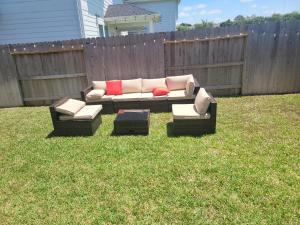 a couch sitting in the grass in a yard at Ts3 Houston in Missouri City