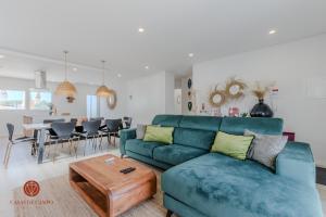 a living room with a blue couch and a table at Casas de Campo - Vale da Terça in Vermelha +50 photos