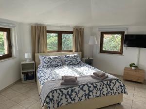 a bedroom with a bed with two towels on it at All You Need Holiday in Pula