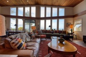 a living room with a couch and a table at #StayinMyDistrict Cape Arago Sanctuary at the Sea in Coos Bay +63 photos