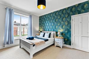 a bedroom with a white bed and a window at Stylish 6-BR home, Monthly Savings, Free Parking in Nether Edge