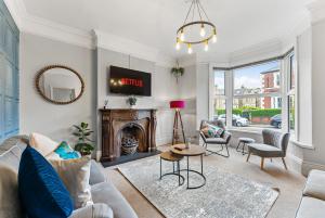 a living room with a couch and a fireplace at Stylish 6-BR home, Monthly Savings, Free Parking in Nether Edge