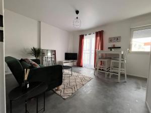 a living room with a couch and a table at Nancy Autre Canal Chez Hélo in Nancy