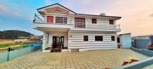 a house on the top of a building at AJ Groups B&B Residency in Ooty