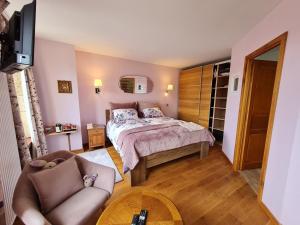 BoismontにあるChambre confortable avec salle d'eau privative - FR-1-584-326のベッドとソファとテーブルのある寝室