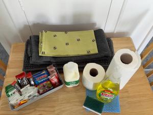 a table with toilet paper and a bag on it at 21 M&T Chalets ,2 bed chalet Florida holiday park , Hemsby in Hemsby