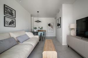 a living room with a couch and a table at Luxury Apartment in Mil Palmeras in Dehesa de Campoamor