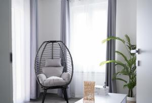 a rattan chair with a pillow in a room at Appartamento Regina Margherita in Crotone