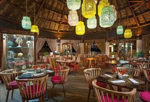 un ristorante con tavoli, sedie e luci di 2BD Grand Bliss Vidanta Resort Riviera Maya a Playa del Carmen