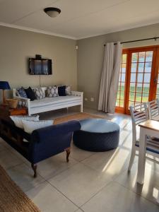 a living room with a couch and a table at The Cottage in Cradock