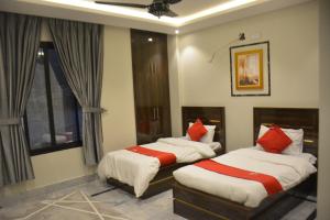 two beds in a bedroom with a window at Lemuna Hotel & Restaurant in Swat +33 photos