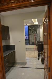 a view from the kitchen into the dining room at Lemuna Hotel & Restaurant in Swat