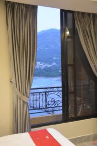a bedroom with a window with a view at Lemuna Hotel & Restaurant in Swat