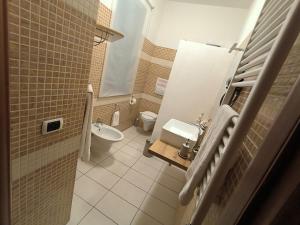 a small bathroom with a toilet and a sink at Le perle 2 di Naxos in Giardini Naxos +5 photos