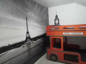 a wall mural of the eiffel tower and a bus at Feel at Home - à 2 pas de la voie Verte & Meuse in Braux