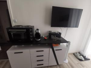 a black counter with a microwave and a television on it at Appartement 223 in Bad Aussee