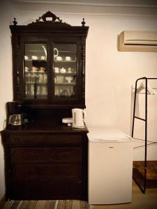a cabinet with dishes in it in a room at Πέτρινο σπίτι δίπλα στη θάλασσα in Votsalákia +29 photos