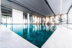 a swimming pool with blue water in a building at The Resort Cyprus Boutique Hotel in Ayios Nikolaos