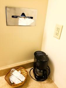 a coffee maker sitting on a counter next to a basket at Americas Best Value Inn Arkansas City in Arkansas City