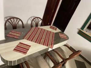 a table with chairs and a table with a table cloth at New Kitisuru Apartment in Nairobi