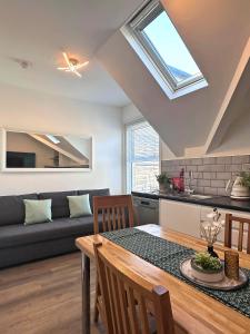 a kitchen and living room with a table and a couch at Granada Apartments at Pleasure Beach in Blackpool