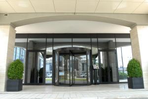 an entrance to a building with revolving doors at Grand Hotel Duca Di Mantova in Sesto San Giovanni