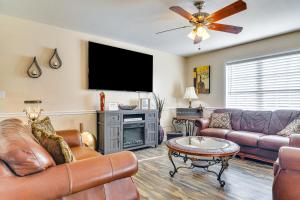 a living room with leather furniture and a flat screen tv at Central High Point Home Less Than 1 Mi to Downtown! in High Point