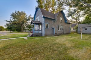 a house with a blue roof on a yard at South Dakota Hideaway Walk to Dtwn Redfield in Redfield