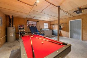 a pool table in the middle of a room at NEW Toccoa River Front - HotTub Fire pit Game Room in Mineral Bluff