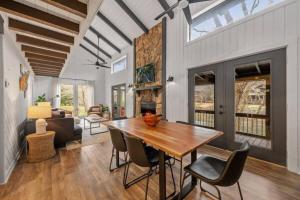 a dining room with a wooden table and chairs at NEW Toccoa River Front - HotTub Fire pit Game Room in Mineral Bluff