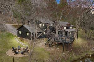 an aerial view of a house with a table and chairs at NEW Toccoa River Front - HotTub Fire pit Game Room in Mineral Bluff