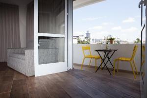 an open door to a balcony with a table and chairs at Dizengoff Square Boutique Aparthotel - by BAR COLLECTION in Tel Aviv