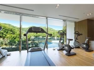 a gym with cardio machines and a view of a pool at Olive Bay Hotel - Vacation STAY 75564v in Saikai