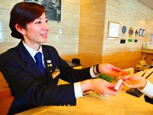 a woman in a suit sitting at a table eating food at TSUYAMA KAKUZAN HOTEL - Vacation STAY 75710v in Tuyama