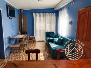 a blue living room with a couch and a table at CABAÑA OSORNO Ruta 215 in Osorno