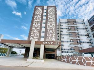 a tall building with a sign in front of it at Spazzio com acesso ao Acqua Park - Temporada CN Adriele in Caldas Novas