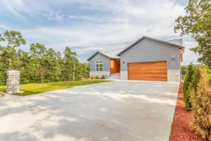 a house with a large driveway with a garage at Hideaway in a Luxurious Location in Saint Robert