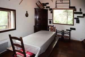 a bedroom with a bed and some chairs and a window at Résidence Chal. Les Chandelles - CHALET Les Chandelles 11 Pers. PIED PISTES MAE-6521 in Les Orres