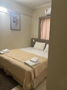 a bedroom with a bed with two towels on it at Druds Hotel in Três Lagoas +13 photos