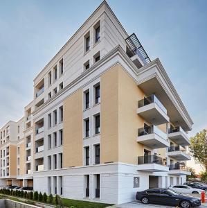 a building with a car parked in front of it at App Town North Pipera 32 in Voluntari