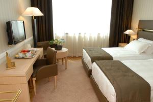 מיטה או מיטות בחדר ב-Grand Hotel Duca Di Mantova