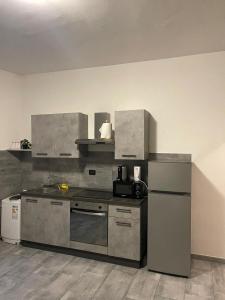 a kitchen with a stove and a refrigerator at b&b da Patrizia in Turin