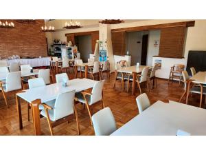 a dining room with white tables and white chairs at THE RETREATMENT YUGAWARA - Vacation STAY 86817v in Yoshihama